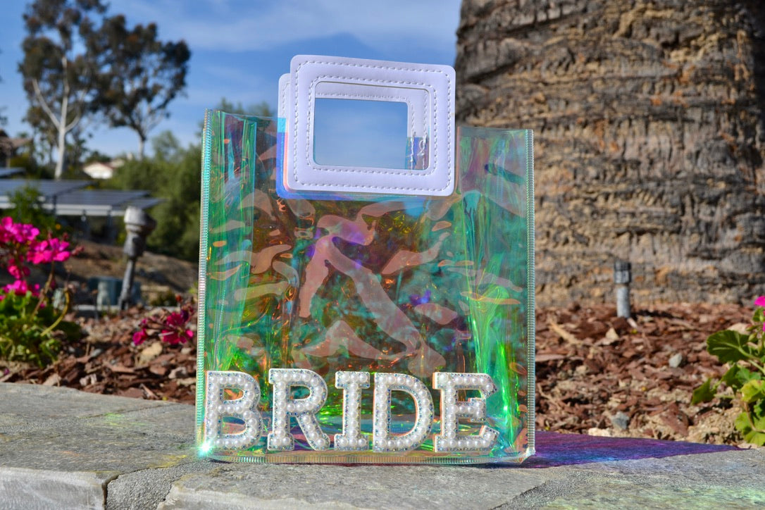 Close-up of clear holographic bride mini bag with sparkling finish.