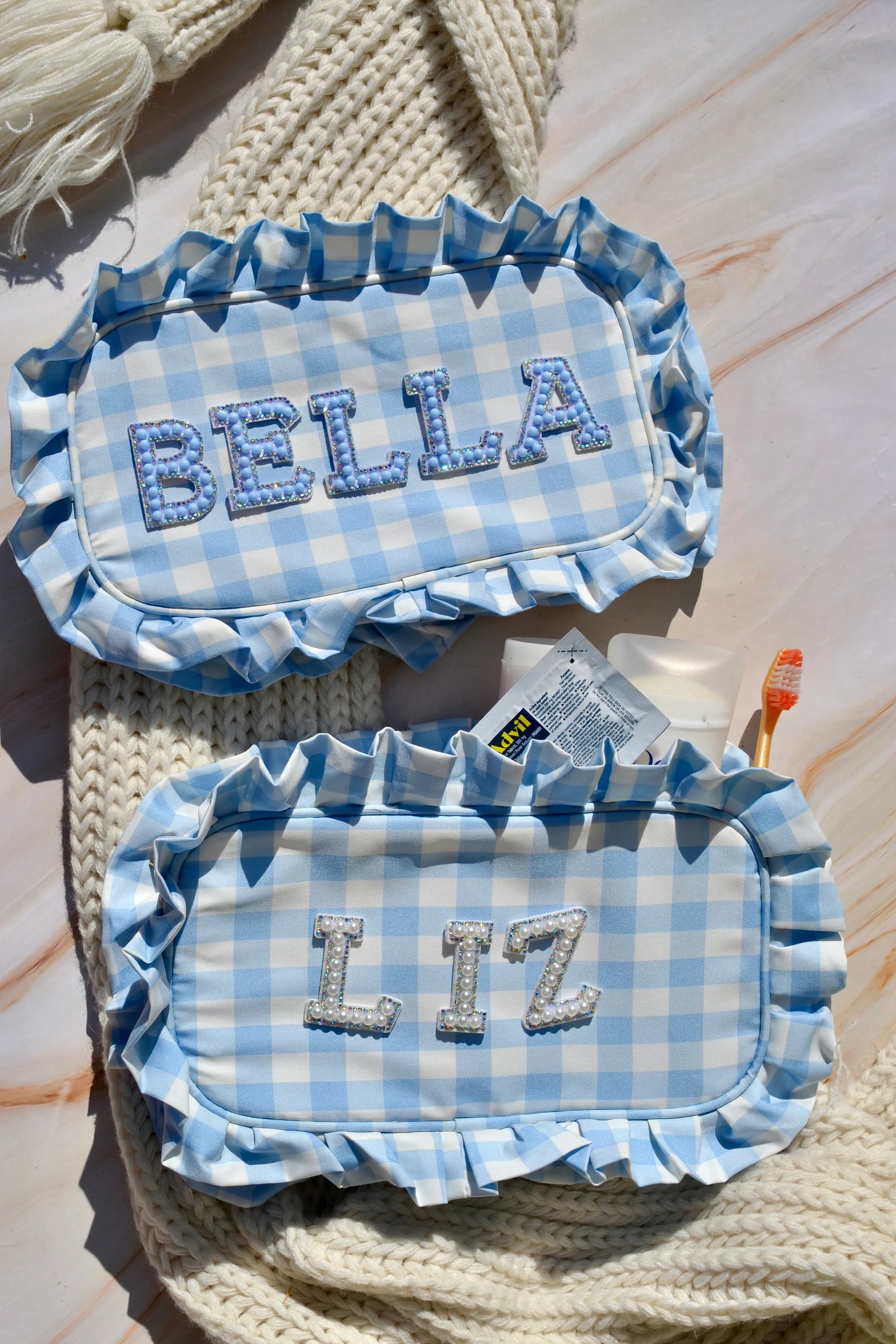 Front view of custom monogrammed blue makeup bag with zipper