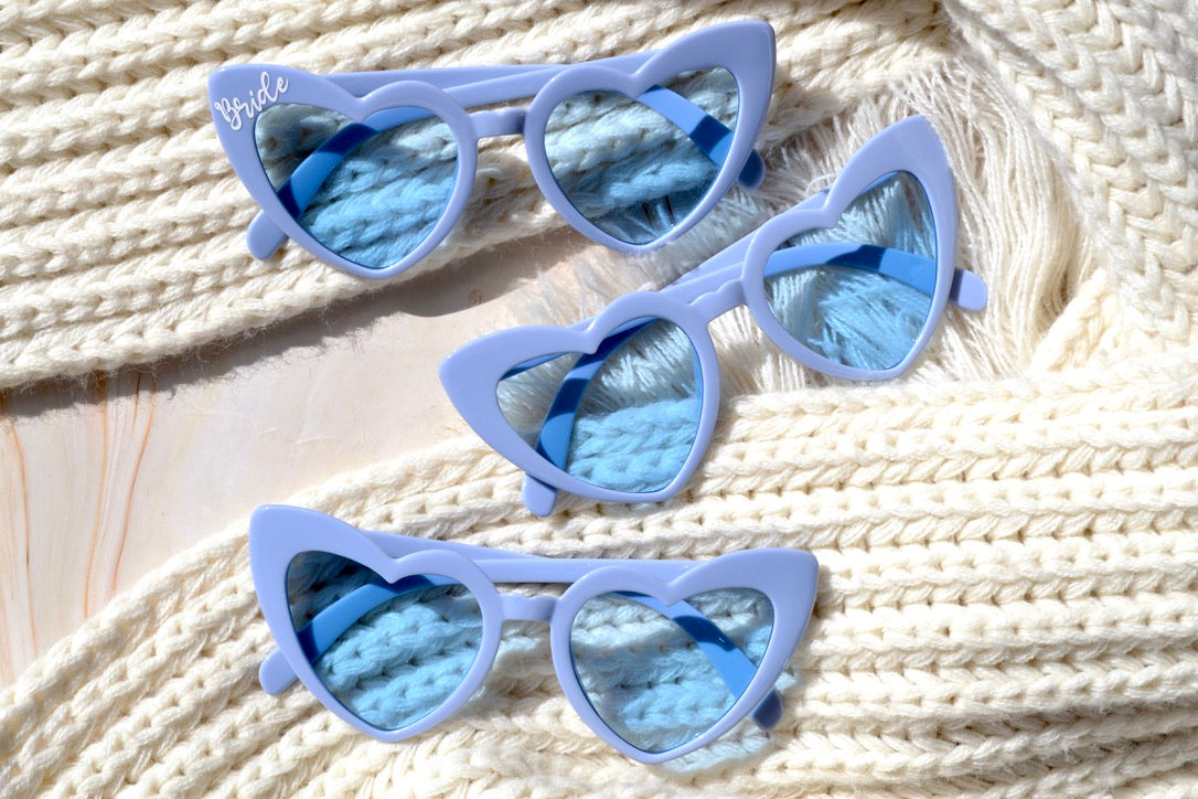 Dusty blue heart-shaped sunglasses for coastal bachelorette party favors