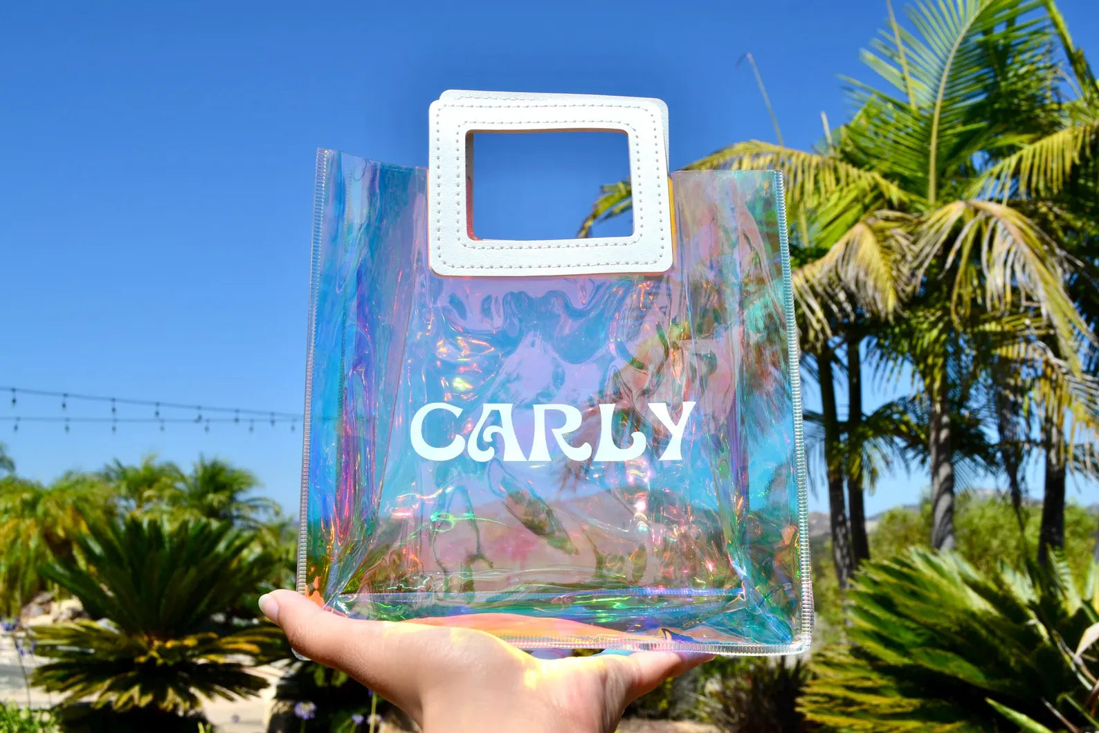 Holographic tote bag displaying color-changing effect, suitable for festive occasions